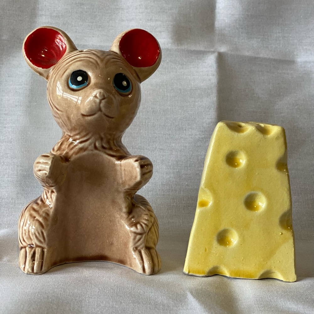 Vintage large brown rat holding Swiss cheese